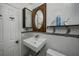 Contemporary bathroom with a modern floating sink, stylish mirror, and built-in shelving, maximizing space at 1683 Pine St, Largo, FL 33774
