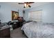 Comfortable bedroom with a large bed, blue walls, ceiling fan, and framed artwork at 1683 Pine St, Largo, FL 33774