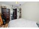 Cozy bedroom with white walls and accents, dark wood wardrobe and a comfortable bed at 1683 Pine St, Largo, FL 33774