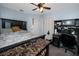 Bedroom features a large bed with a ceiling fan, closet, and workstation at 1683 Pine St, Largo, FL 33774