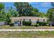 Charming single-story home featuring a well-maintained front yard and a welcoming facade at 1683 Pine St, Largo, FL 33774