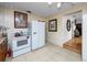 View of kitchen with access to other parts of the house, stove and refrigerator at 1683 Pine St, Largo, FL 33774