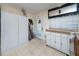 Kitchen with tile flooring, backyard access and cabinets for ample storage at 1683 Pine St, Largo, FL 33774