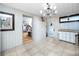 Spacious kitchen area with access to the backyard, tile flooring and white paneled walls at 1683 Pine St, Largo, FL 33774