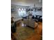 Inviting living room with hardwood floors, piano, and area rug creating a cozy atmosphere for relaxation at 1683 Pine St, Largo, FL 33774