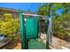 Private outdoor shower area with green painted wood for post-swim refreshment at 1683 Pine St, Largo, FL 33774