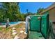 Outdoor shower with lush landscaping, and swimming pool create a serene and private backyard retreat at 1683 Pine St, Largo, FL 33774