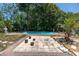 A backyard pool area is enhanced by a tiled patio and whimsical accents, offering an inviting space for relaxation at 1683 Pine St, Largo, FL 33774