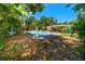 Inviting backyard pool complemented by statues and mature landscaping at 1683 Pine St, Largo, FL 33774