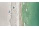 Overhead view showcases the sandy beach and shimmering turquoise ocean waters at 17710 Gulf Blvd # 304, Redington Shores, FL 33708