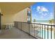 Spacious balcony showcasing beautiful views of the white sand beach, turquoise ocean, and community pool at 17710 Gulf Blvd # 304, Redington Shores, FL 33708