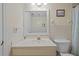 Clean bathroom features a vanity with sink, a mirror, and a toilet with decorative artwork at 17710 Gulf Blvd # 304, Redington Shores, FL 33708