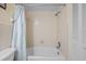 This bathroom features a shower/tub combination with curtain and tiled walls, adjacent to the toilet at 17710 Gulf Blvd # 304, Redington Shores, FL 33708