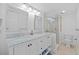 Elegant bathroom with double sinks, a glass-enclosed shower, and stylish fixtures, creating a spa-like experience at 17710 Gulf Blvd # 304, Redington Shores, FL 33708