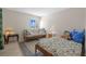 Cozy bedroom features a floral-print bedspread and a comfortable futon for additional seating at 17710 Gulf Blvd # 304, Redington Shores, FL 33708