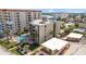 Beachfront condo building with lush landscaping, a sparkling pool, and Gulf views at 17710 Gulf Blvd # 304, Redington Shores, FL 33708