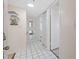 Inviting foyer with tiled flooring, neutral walls, decorative mirrors, and a view into other rooms of the home at 17710 Gulf Blvd # 304, Redington Shores, FL 33708