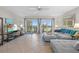 Cozy living room featuring balcony access with ocean views, comfortable seating, and natural light at 17710 Gulf Blvd # 304, Redington Shores, FL 33708