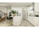 Stylish kitchen featuring an island with bar stools, modern appliances, and sleek cabinetry, perfect for cooking and entertaining at 18154 Serene Lake Loop, Lutz, FL 33548