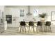 Modern kitchen boasting stainless steel appliances, a sleek island with seating, and ample natural light, ideal for cooking at 18154 Serene Lake Loop, Lutz, FL 33548