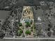Aerial view of estate home with pool on large lot surrounded by trees and landscaping at 18577 Clay Hill Rd, Dade City, FL 33523