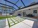 The backyard boasts a covered patio, pool, and manicured lawn for outdoor enjoyment at 18577 Clay Hill Rd, Dade City, FL 33523