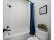 Bathroom with tiled shower and tub, toilet, and minimalist decor at 18577 Clay Hill Rd, Dade City, FL 33523