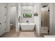 Modern bathroom with a soaking tub, glass shower, and stylish fixtures at 18577 Clay Hill Rd, Dade City, FL 33523
