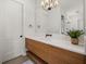 Bathroom boasting wood vanity, modern fixtures, white countertops, and ample lighting at 18577 Clay Hill Rd, Dade City, FL 33523