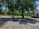 Circular driveway leading to a home with mature trees and a well-manicured lawn at 18577 Clay Hill Rd, Dade City, FL 33523