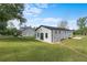 View of the home and outbuilding, with a black roof and modern architecture at 18577 Clay Hill Rd, Dade City, FL 33523