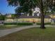 Stunning exterior featuring manicured landscaping, a circular drive, and a charming white facade at 18577 Clay Hill Rd, Dade City, FL 33523