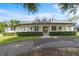 Inviting single-Gathering home with a classic white facade and beautifully landscaped yard at 18577 Clay Hill Rd, Dade City, FL 33523