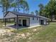 Spacious metal building with large overhangs and a concrete pad perfect for parking or outdoor activities at 18577 Clay Hill Rd, Dade City, FL 33523