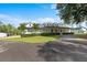Beautifully landscaped front yard with lush greenery and a driveway leading to the home at 18577 Clay Hill Rd, Dade City, FL 33523