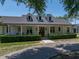 Charming single-story home with a covered front porch and manicured landscaping at 18577 Clay Hill Rd, Dade City, FL 33523