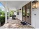 Inviting front porch with brick flooring and traditional rocking chairs at 18577 Clay Hill Rd, Dade City, FL 33523
