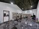 Gym area with a peloton, weight rack, and shelves of helmets at 18577 Clay Hill Rd, Dade City, FL 33523