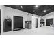 Modern garage featuring epoxy floors, custom cabinetry, and a unique black ceiling at 18577 Clay Hill Rd, Dade City, FL 33523