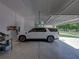 Spacious garage featuring a parked white Denali and shelving at 18577 Clay Hill Rd, Dade City, FL 33523