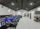 Spacious garage with high ceilings, sleek epoxy flooring, and organized storage areas at 18577 Clay Hill Rd, Dade City, FL 33523