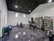 Gym area with a peloton, weight rack, and shelves of helmets at 18577 Clay Hill Rd, Dade City, FL 33523