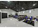 Large garage with motorbikes, air conditioning, cabinets, and a workbench at 18577 Clay Hill Rd, Dade City, FL 33523