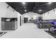 Contemporary garage with high ceilings, polished floors, and custom storage solutions at 18577 Clay Hill Rd, Dade City, FL 33523