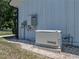 Generac generator on a gravel bed, surrounded by lush greenery, ensuring reliable backup power for the property at 18577 Clay Hill Rd, Dade City, FL 33523