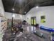 Home gym featuring exercise equipment, a trophy display and a sleek epoxy floor at 18577 Clay Hill Rd, Dade City, FL 33523