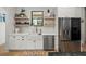 Bright kitchen featuring white cabinets, modern appliances, and butcher block shelving at 18577 Clay Hill Rd, Dade City, FL 33523