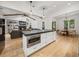Open kitchen featuring a large island with a built-in microwave and granite countertops at 18577 Clay Hill Rd, Dade City, FL 33523