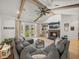 Spacious living room featuring a fireplace, beamed ceilings, and ample natural light at 18577 Clay Hill Rd, Dade City, FL 33523