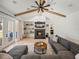 Cozy living room with a fireplace, hardwood floors, and plenty of natural light at 18577 Clay Hill Rd, Dade City, FL 33523